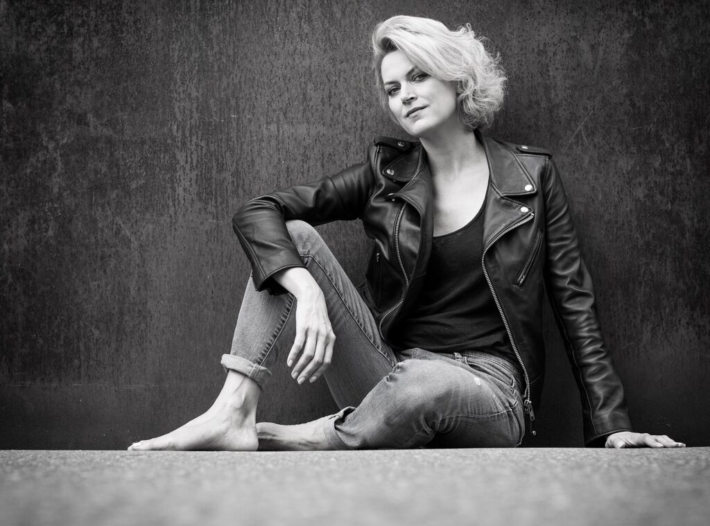 Woman styling a leather jacket with denim in a balanced everyday look