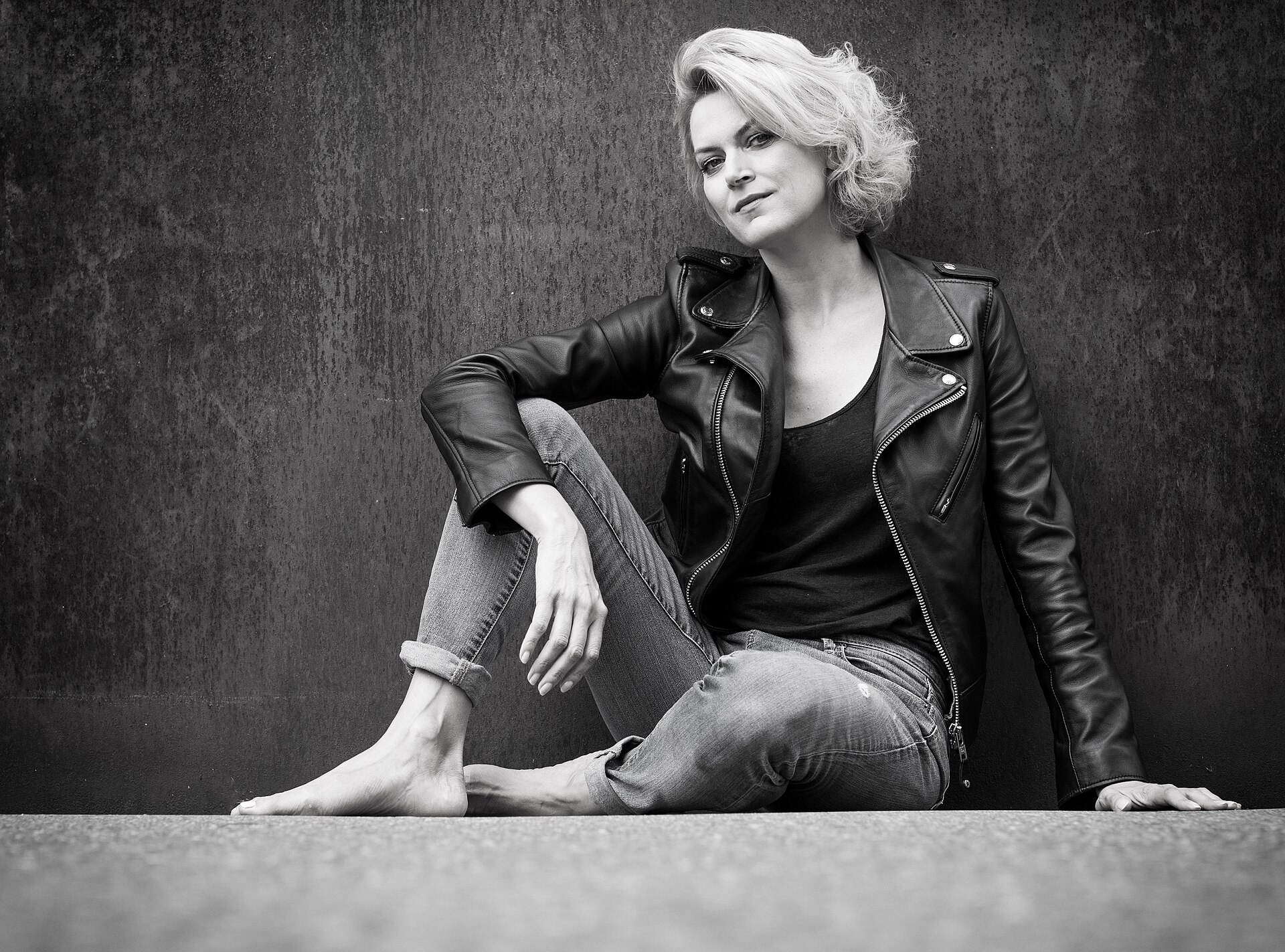 Woman styling a leather jacket with denim in a balanced everyday look