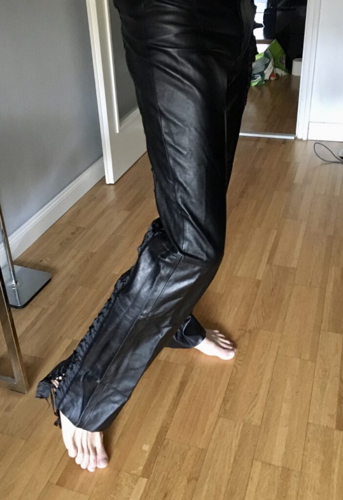 Woman wearing black leather trousers in a restrained tonal outfit