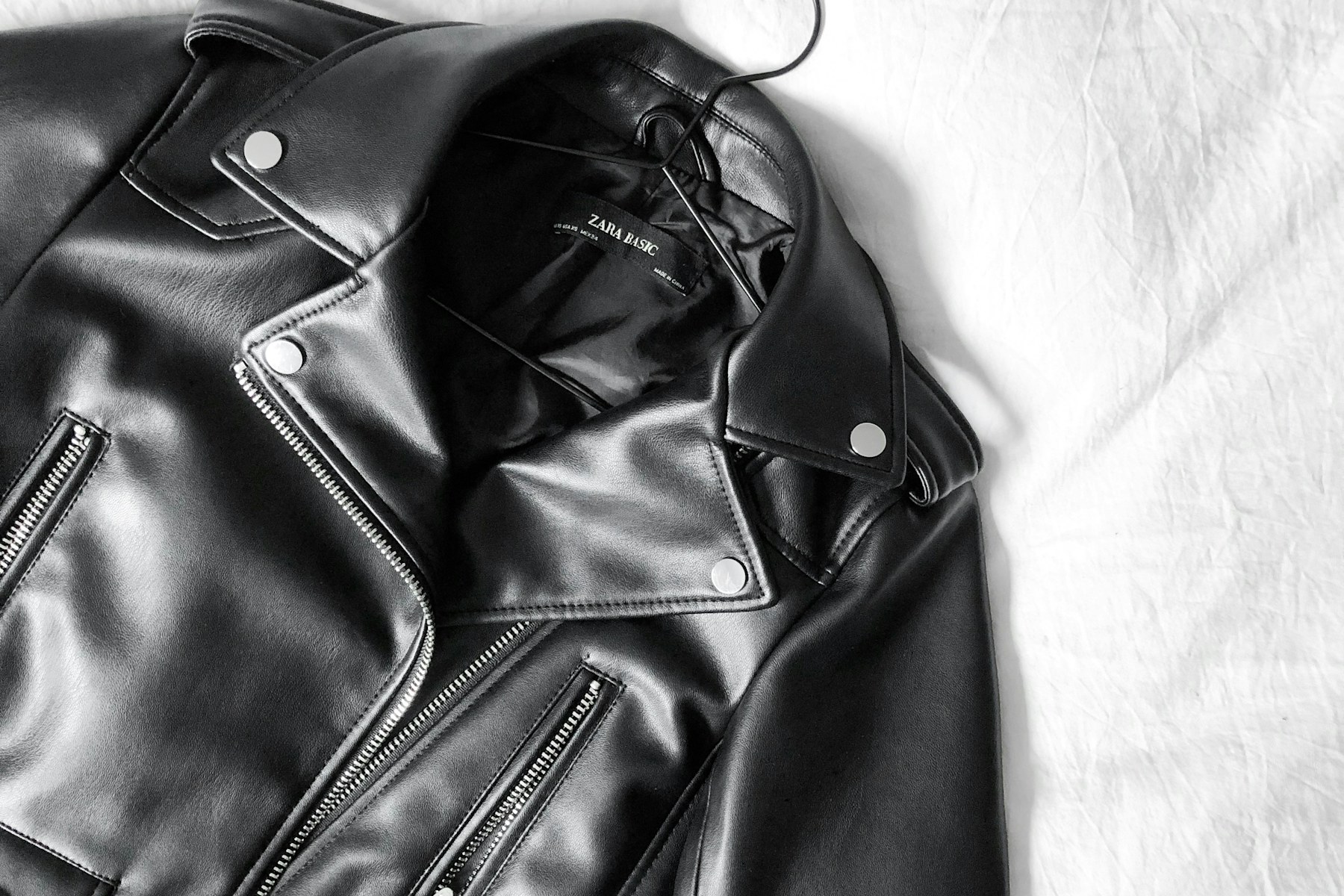 Black leather jacket laid flat for close inspection
